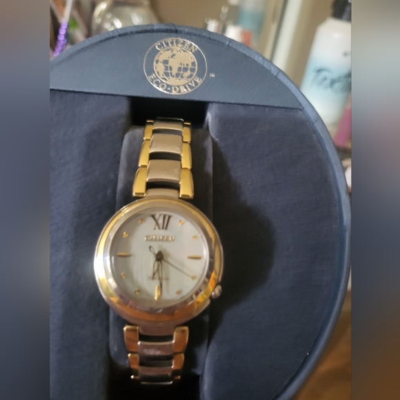 Citizens women's Eco-Drive watch with a pearl face and gold trim and a gold hand - Picture 8 of 13